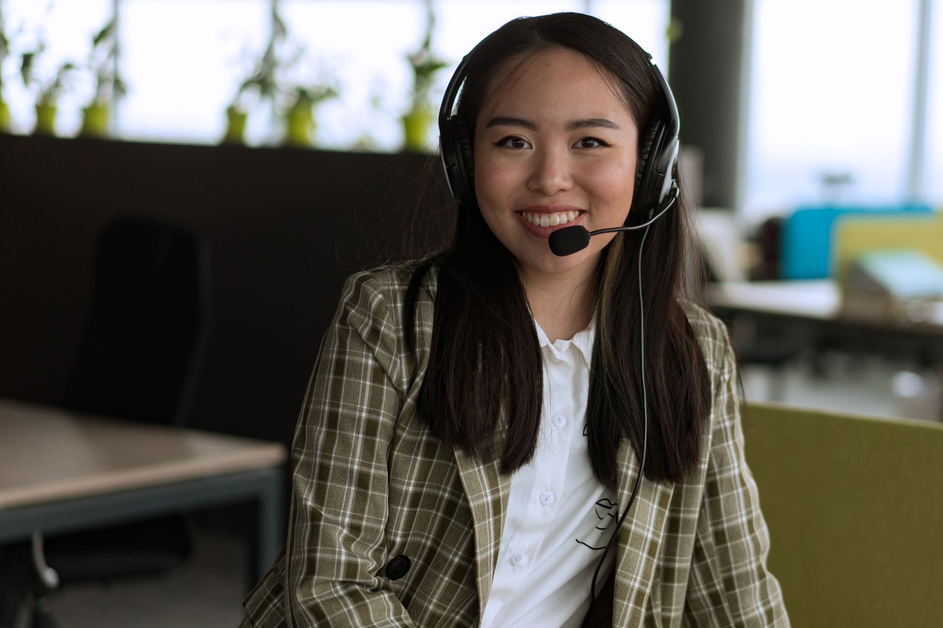 A friendly Swim Jets Australia support specialist wearing a headset, ready to help